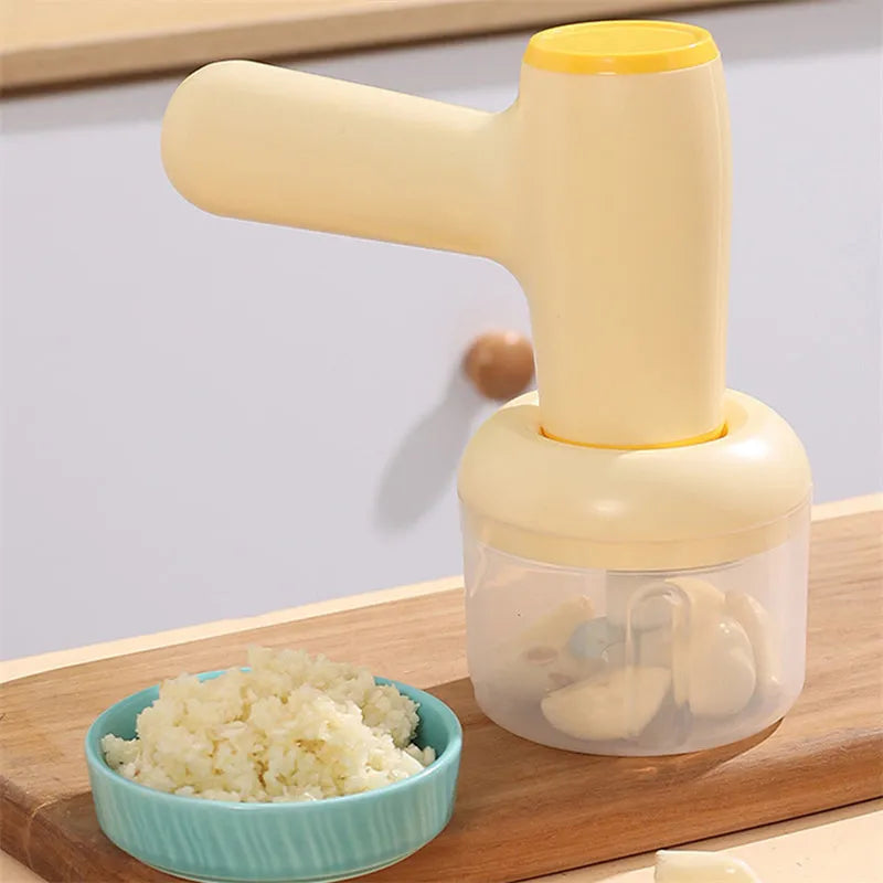 Beige yellow USB rechargeable electric garlic chopper with 250ml cup and 304 blade on a kitchen counter