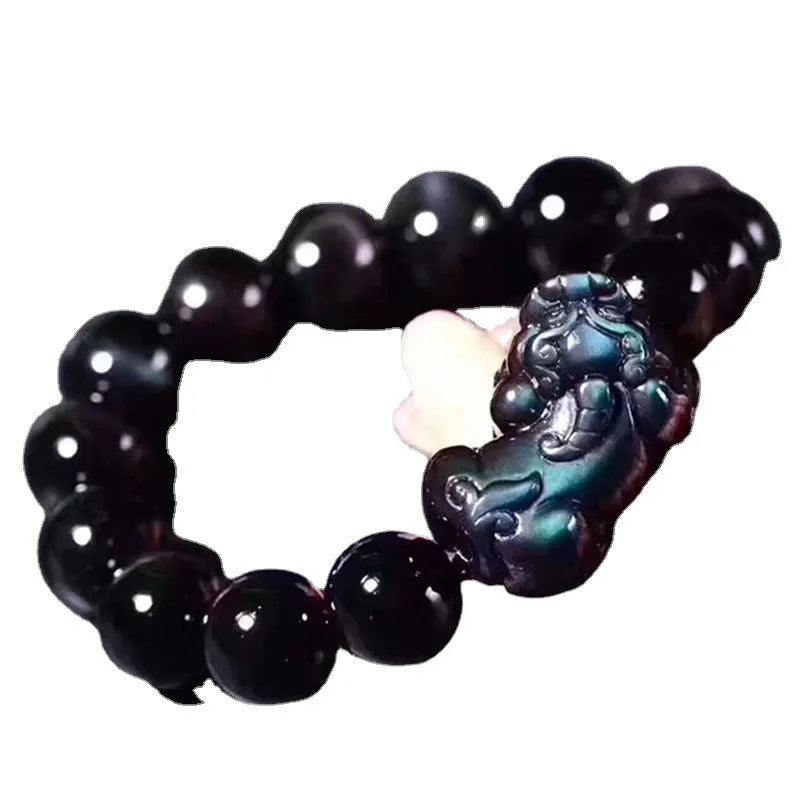 Natural ice colour eye obsidian crystal bead bracelet with spherical beads on wrist.