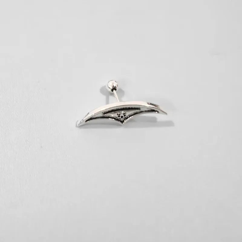 Close-up of geometric spider web patterned metal stud earrings in a gold electroplated finish.