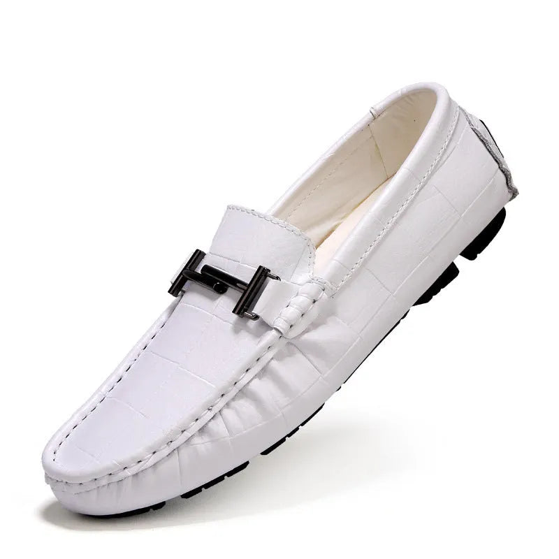 Men's brown leather slip-on loafers with a silver belt buckle detail on the front.