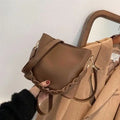 Retro style brown PU leather underarm bucket bag with woven design detail.