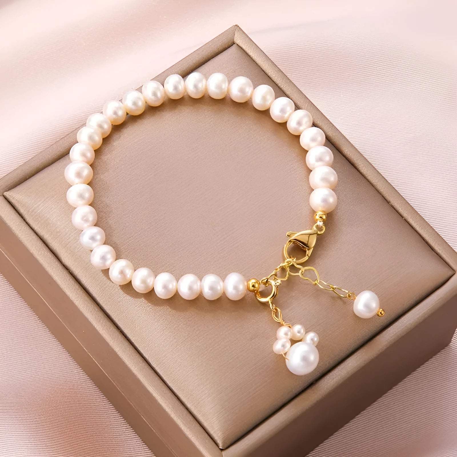 Women's white freshwater pearl cat's paw bracelet with electroplating finish on a neutral background