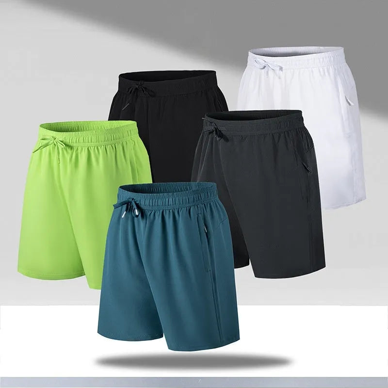 Man wearing loose-fit black quick-dry polyester sports shorts on a beach