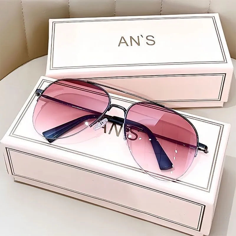 Aviator-style sunglasses with a metal frame and tinted resin lens, shown in a gold frame variant.