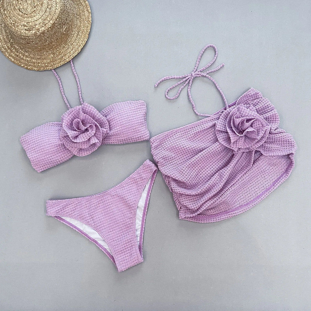 Women's white three-piece bikini with 3D flower split design, showing skirt, bra, and briefs.