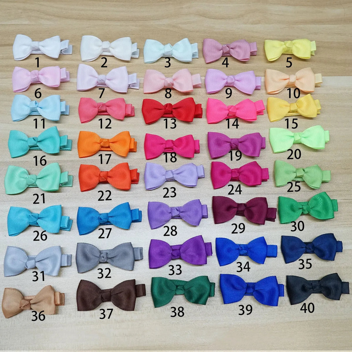 Set of pastel coloured baby hair clips including barrettes and bows on a white background