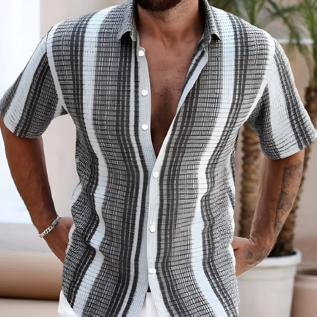 Man wearing a slim fit short sleeve shirt with a colourful 3D floral beach print.
