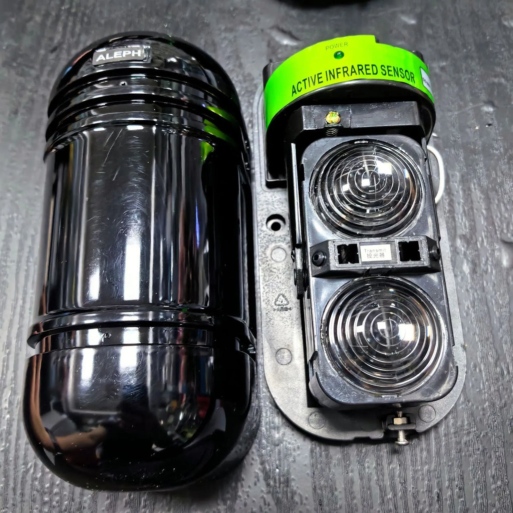 A pair of black infrared detector units for a wired anti-theft alarm system with a 150-metre range.