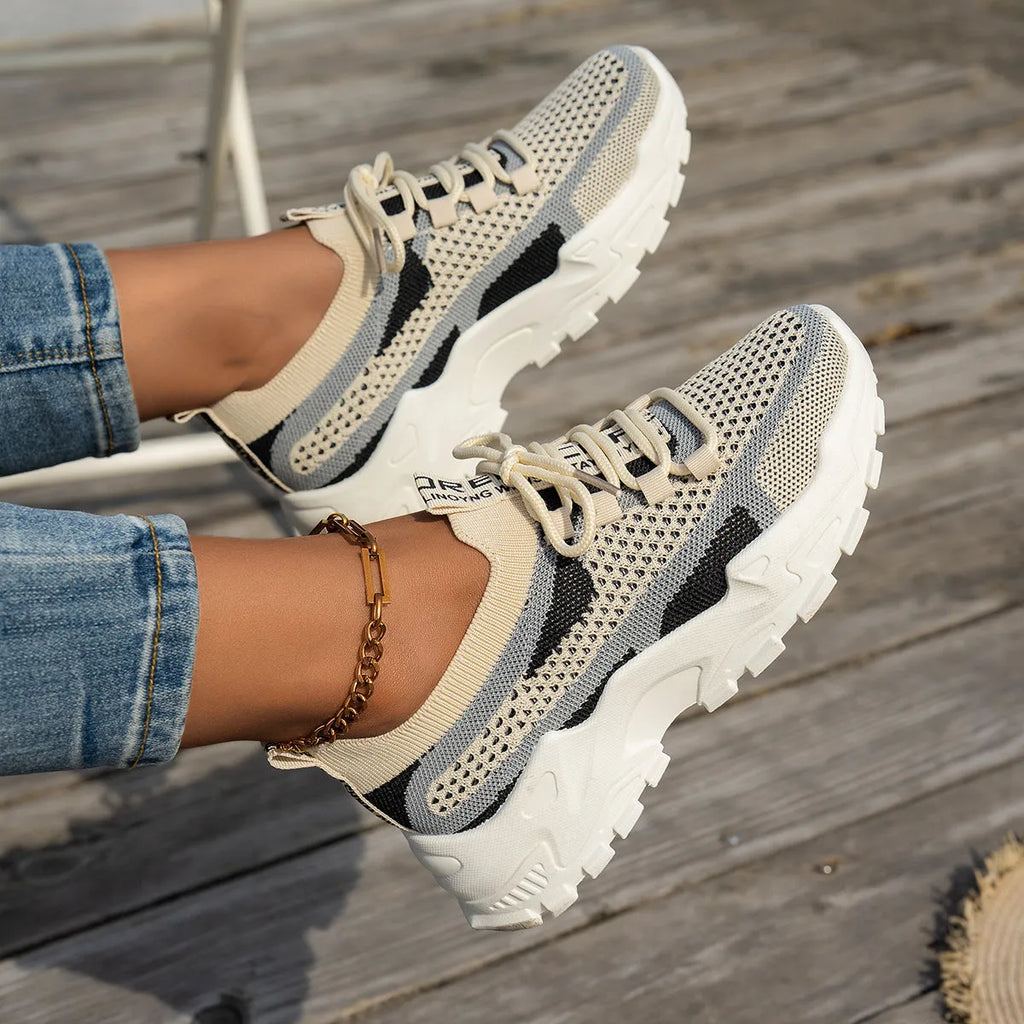 Women's Flyknit mesh lace-up sneakers in various colours on a flat rubber sole.