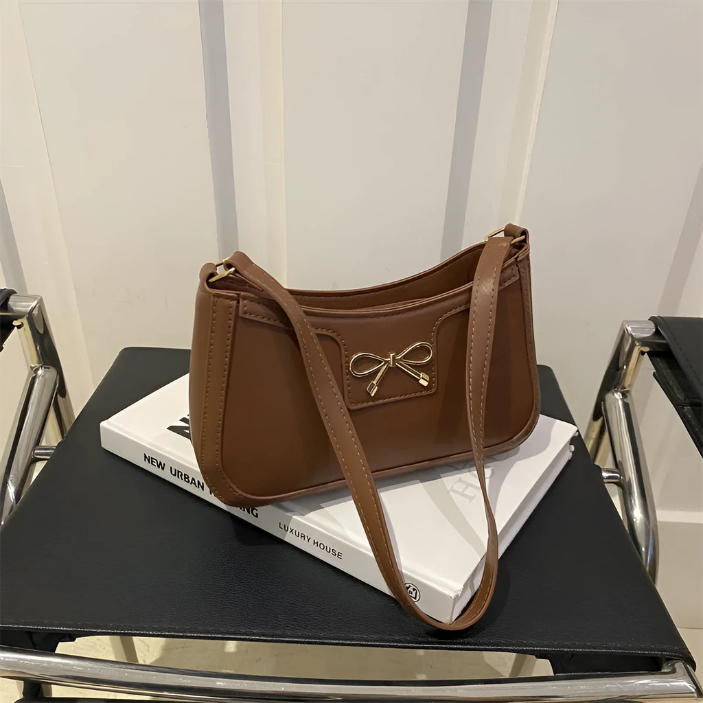 PU leather shoulder bag with bow decoration in a horizontal square shape, shown in one of six available colours.