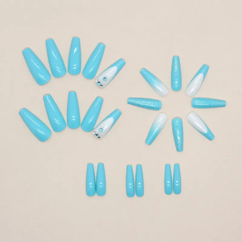 Long smart blue diamond false ballet nails with glitter particles and glue tube.