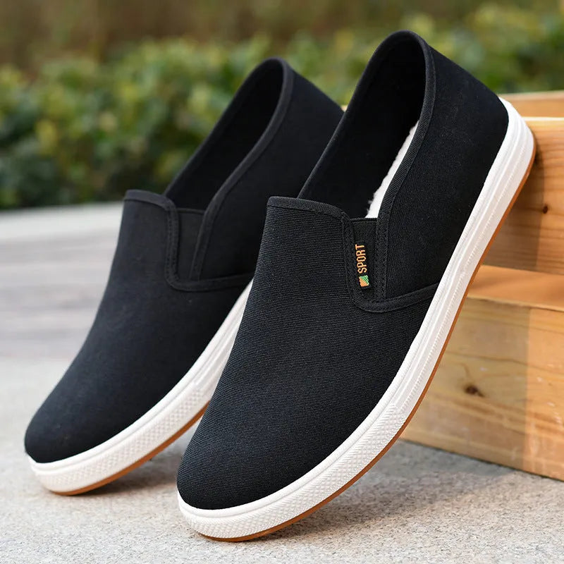 Men's black and blue slip-on canvas trainers with round toe and shallow mouth design