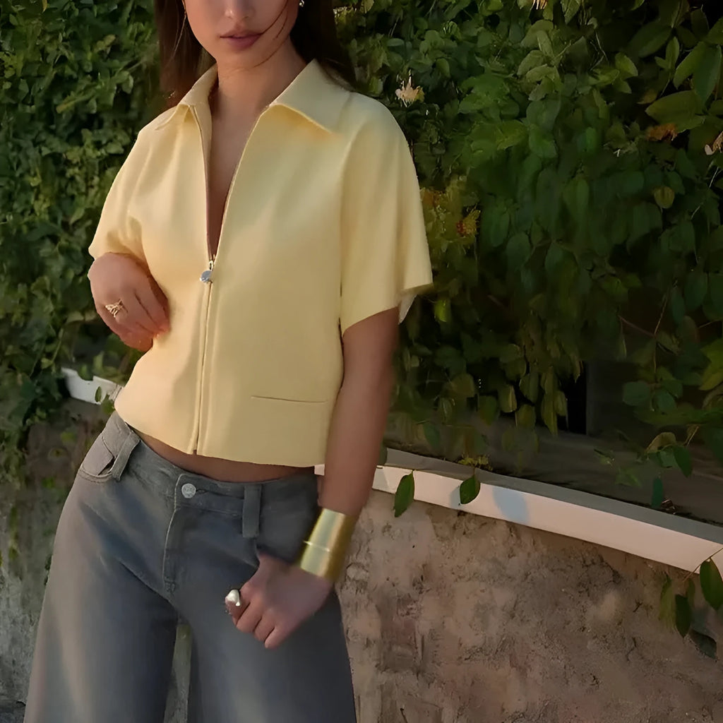 Loose-fit short-sleeve casual top in polyester, shown in white, black, and yellow colour options.
