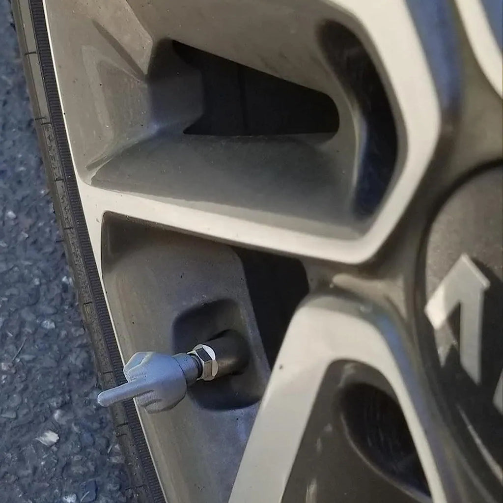Set of four latex car tyre valve dust caps in black and skin colour tones.