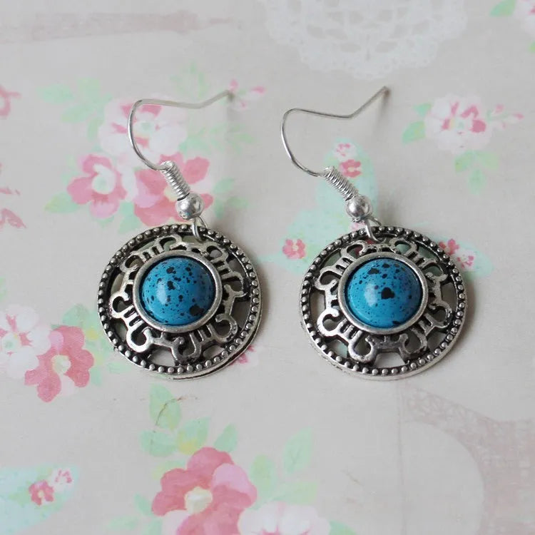 Handmade Miao silver retro earrings with turquoise inlay and geometric flower disk design