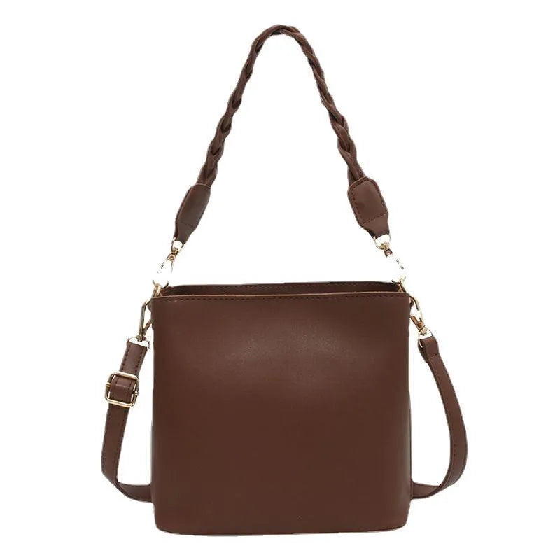 Retro style brown PU leather underarm bucket bag with woven design detail.