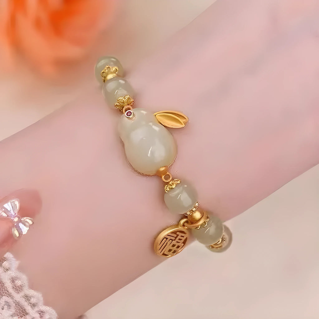 Green jade and black cord women's bracelet with fu character and hare pendant charms
