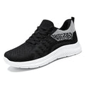 Women's black mesh sneakers with round toe and front lace-up design on soft PVC sole