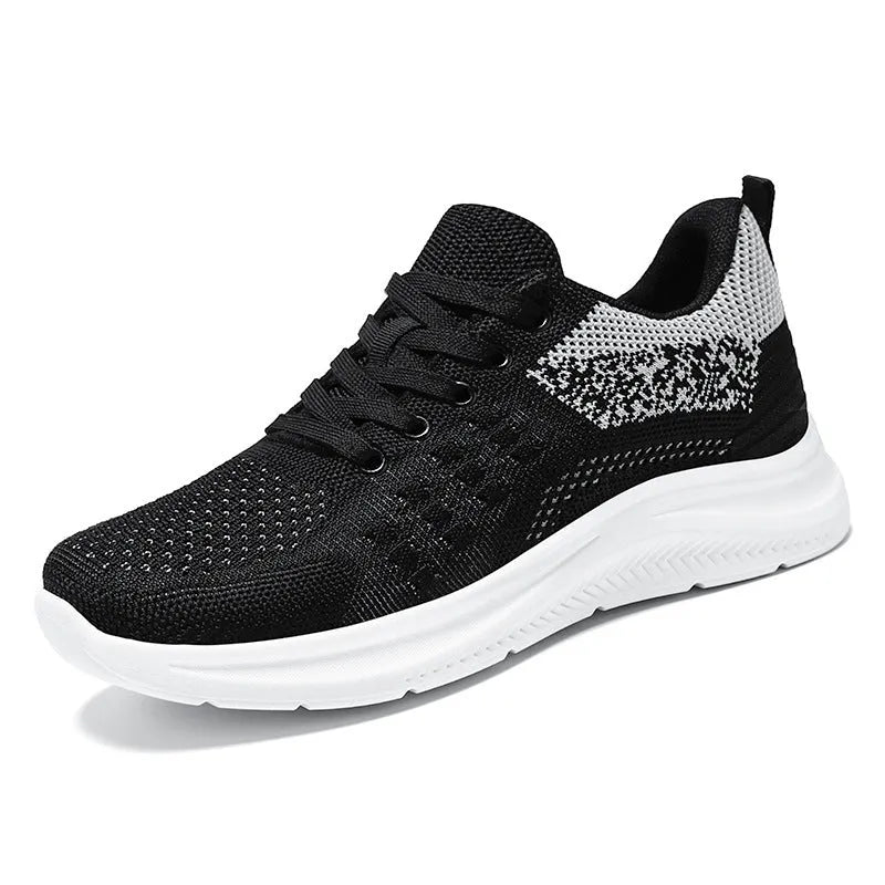 Women's black mesh sneakers with round toe and front lace-up design on soft PVC sole