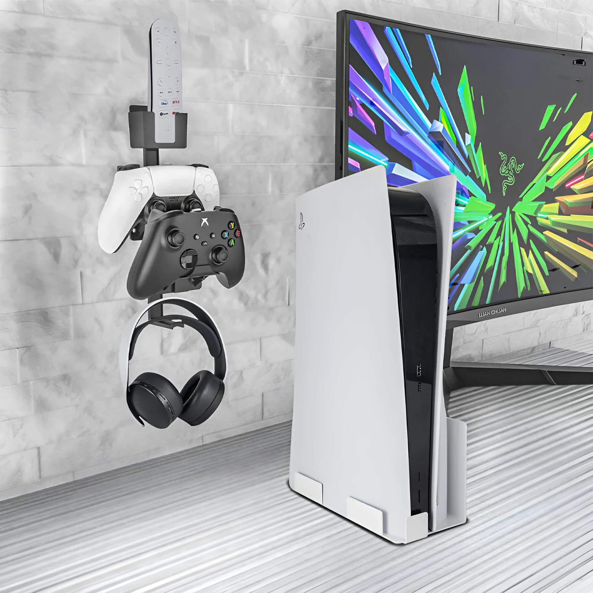 White wall-mounted plastic hook holding a game controller and a pair of headphones.