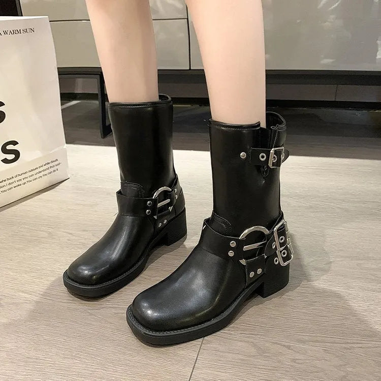 Women's black platform boots with belt buckle decoration at mid-calf length