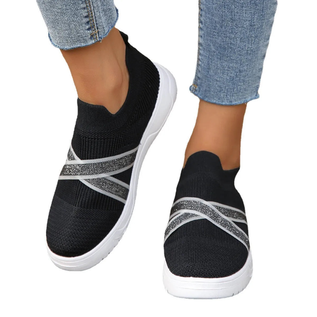 Black women's flat casual shoes with fabric mesh uppers, tassel detail, and a rubber sole.