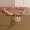 Women's strawberry quartz crystal bracelet with white agate auspicious clouds design