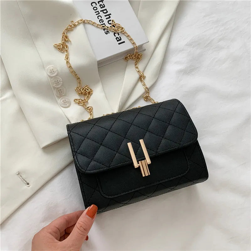 Women's black PU leather crossbody bag with diamond lattice chain detailing and adjustable shoulder strap