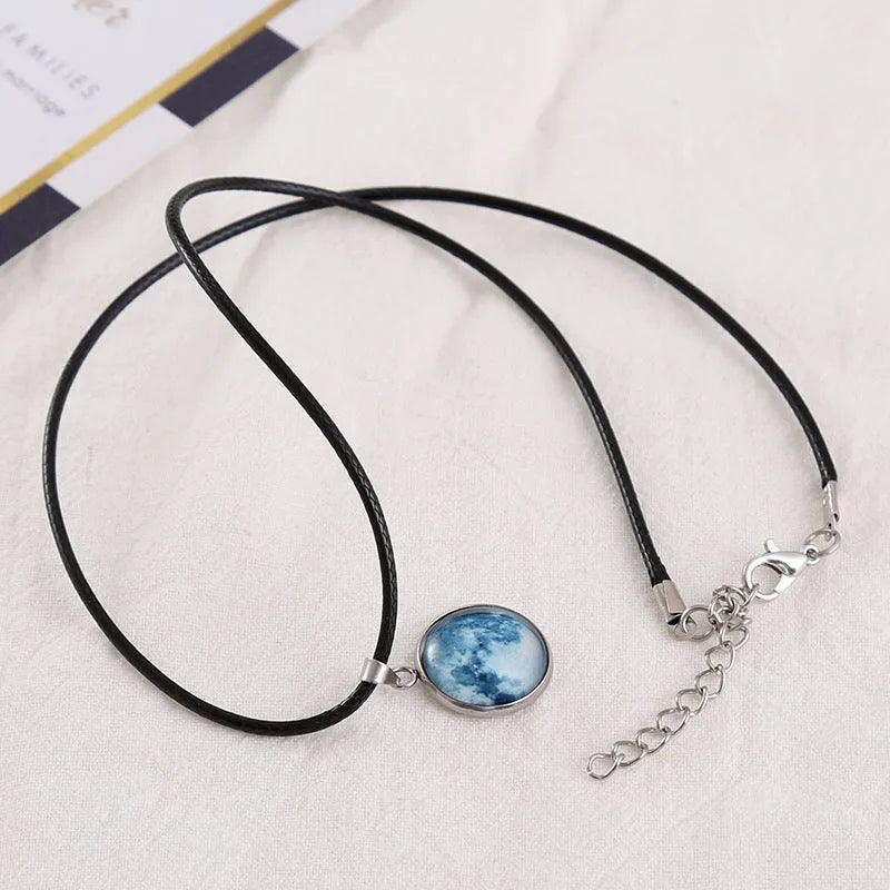 Luminous constellation glass pendant necklace with a moon and night sky design on an adjustable chain