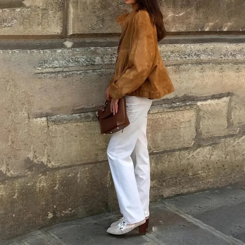 Man wearing a solid colour loose-fit long sleeve retro-style polyester jacket.