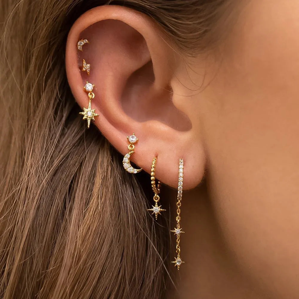 Set of six gold-colour chain tassel earrings with zircon studs, shown arranged together.