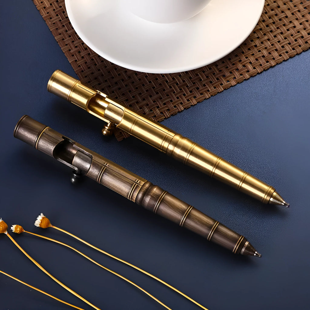 Brass tactical pen with bolt-action mechanism and cylindrical barrel showing six-ring grip detail