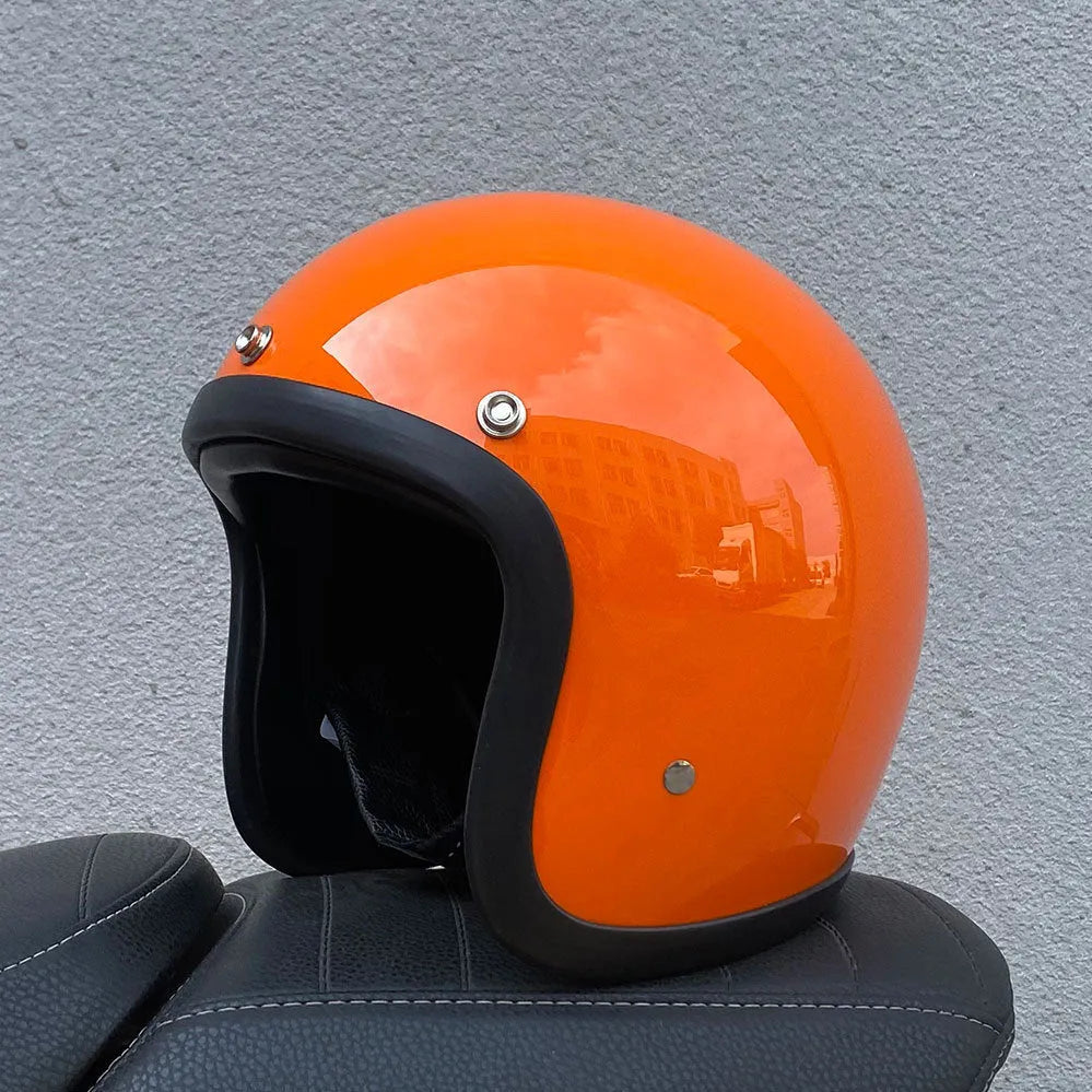 Retro style fibreglass half motorcycle helmet shown in a choice of colours like cement grey and matte black.