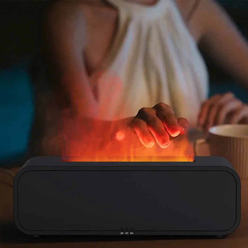 Black and white essential oil diffuser with flame effect and colour-changing lights next to remote control