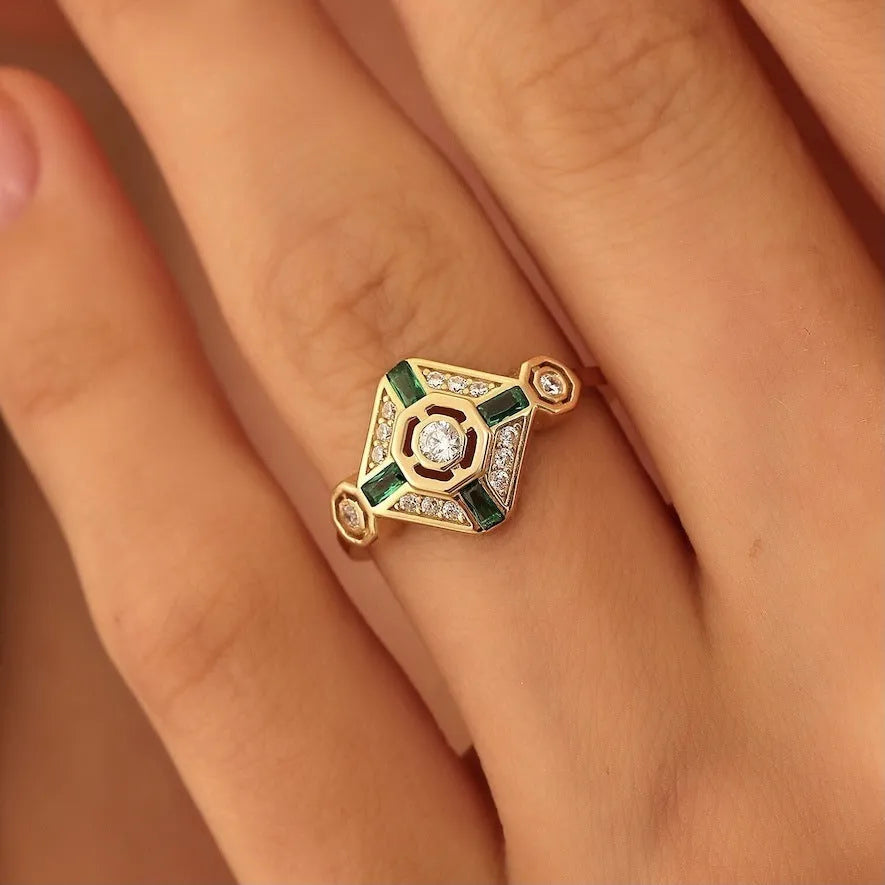 Geometric square emerald diamond ring in lvzuan colour on a model's hand.