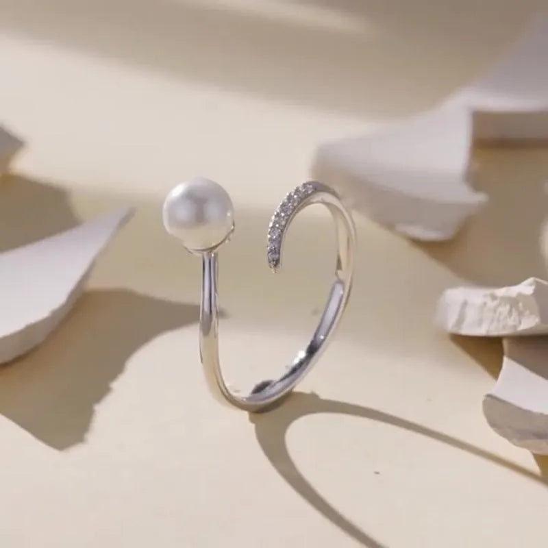 Sterling silver adjustable ring with shell pearls on open loop design
