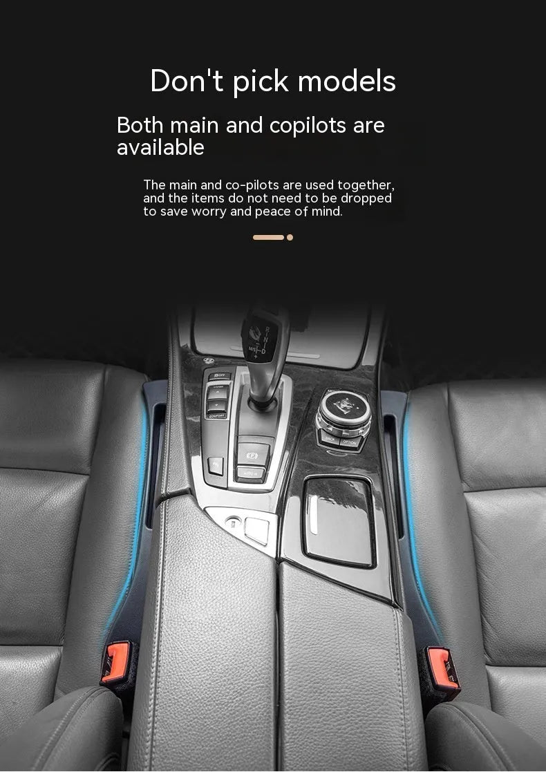 Black plastic car seat gap storage box with handle inserted between car seats.