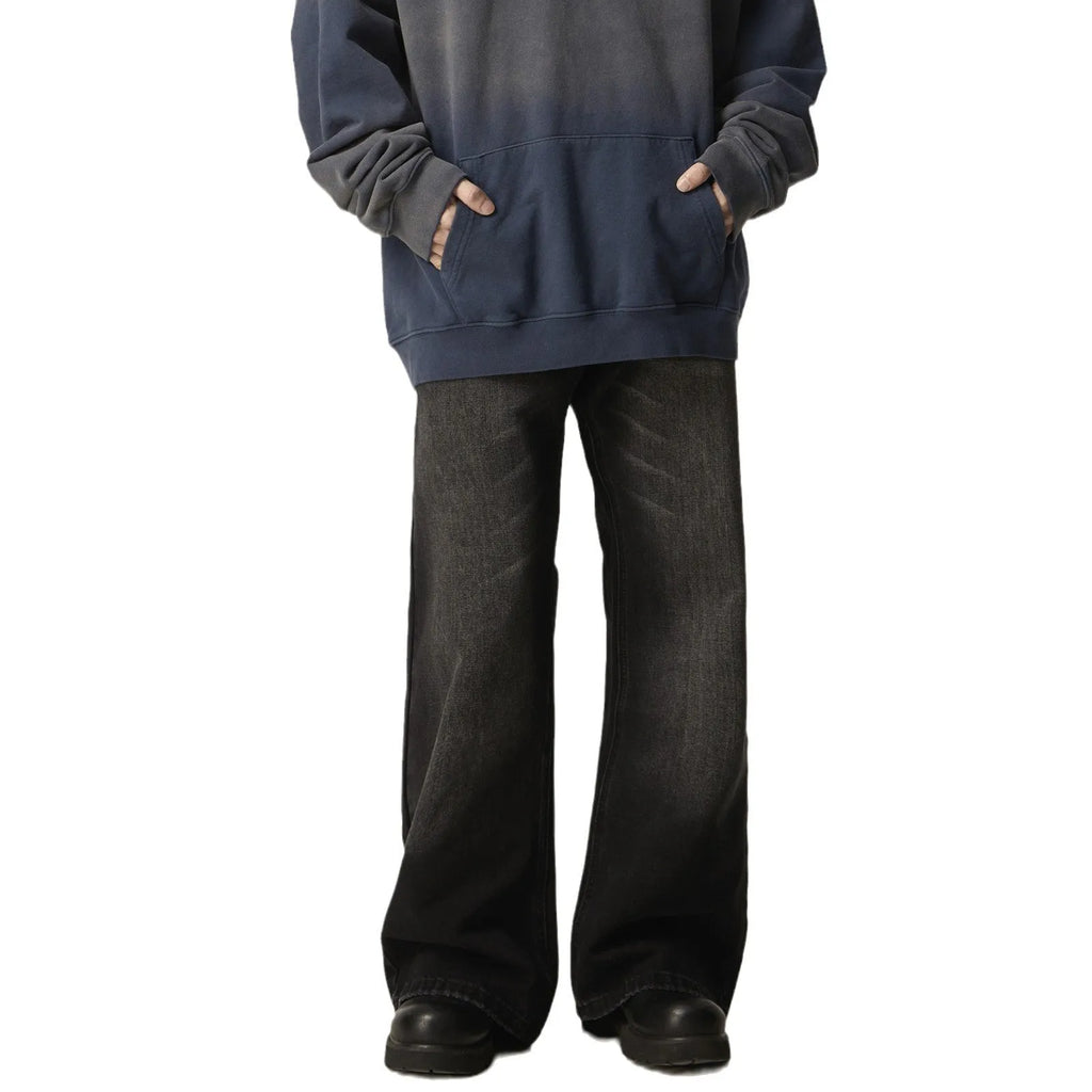 Black loose-fit straight leg denim jeans on a mannequin, showing the zip fly and retro style.