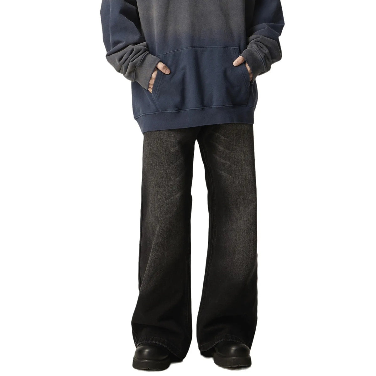 Black loose-fit straight leg denim jeans on a mannequin, showing the zip fly and retro style.