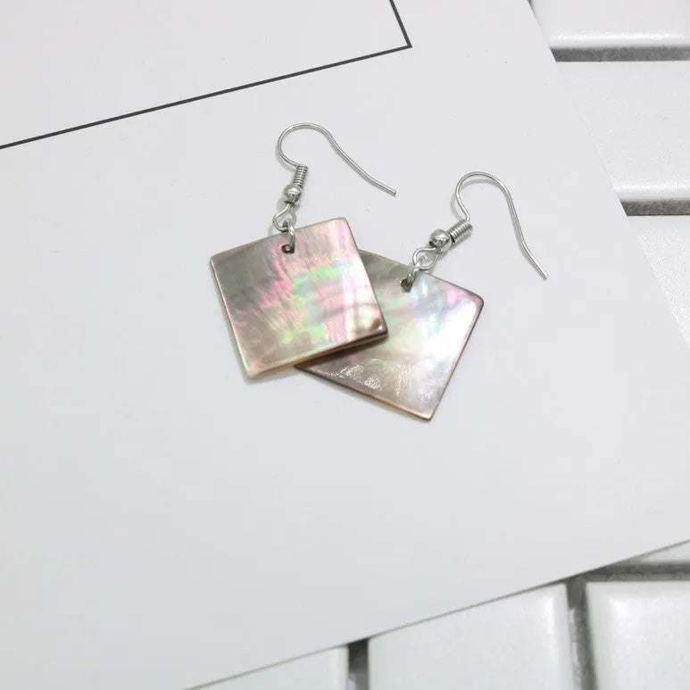 Geometric shell earrings in square panther or rectangular shell styles with natural material texture