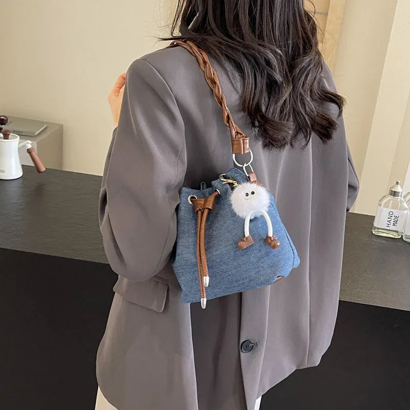 Blue one-shoulder cross body bucket bag with synthetic leather lining and sandwich pocket design