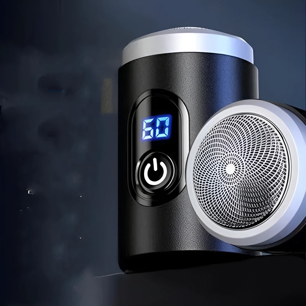Black portable USB rechargeable shaver with cleaning brush and cable on a table.