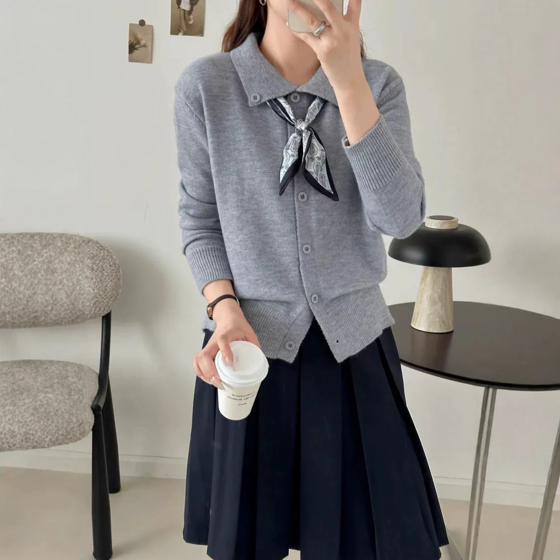 Ladies' grey lapel scarf cardigan sweater on a hanger