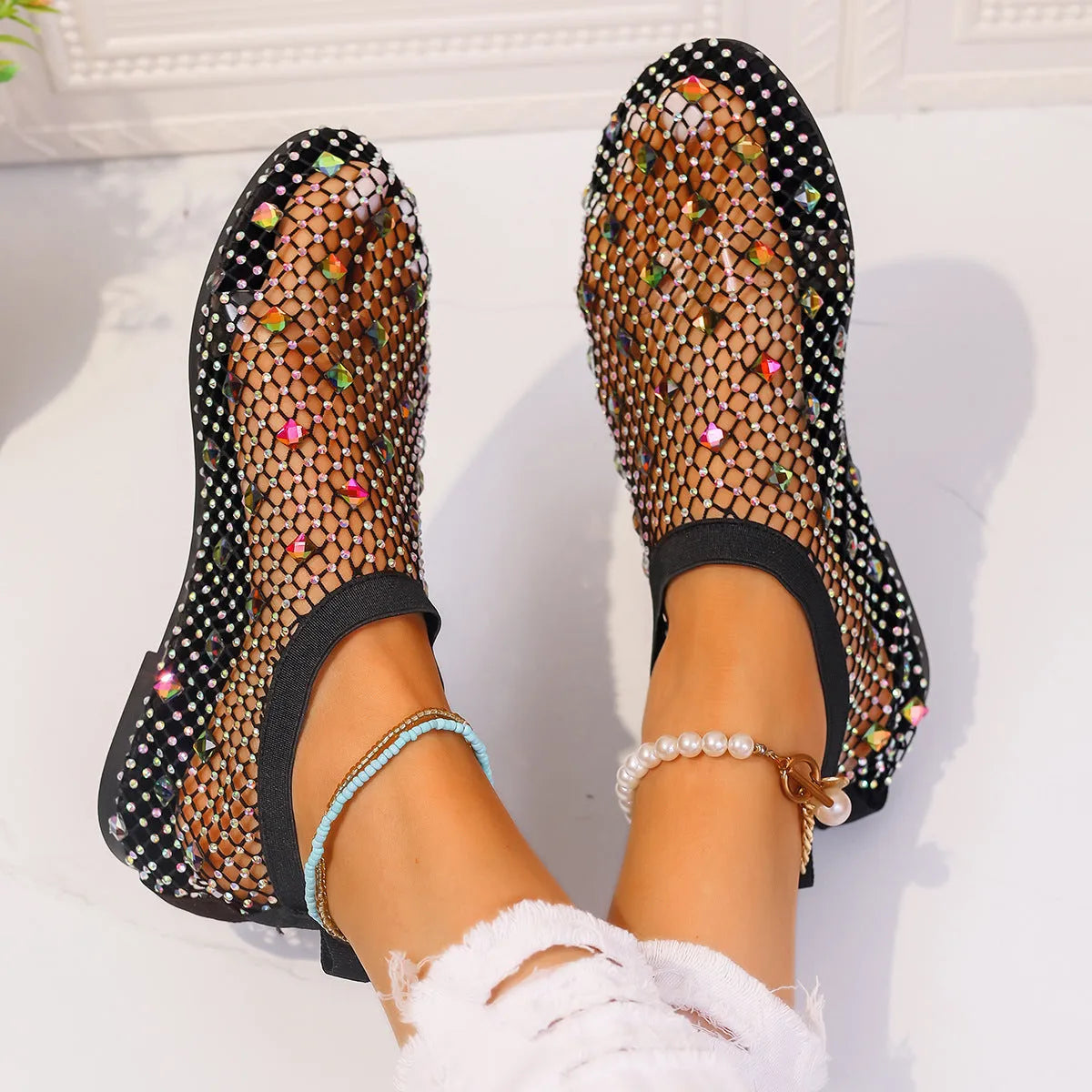 Colourful rhinestone detail on the mesh upper of women's white flat sandals with a round toe.