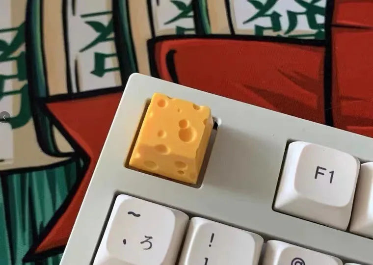 Yellow resin cheese wedge keycap for mechanical keyboards with MX stem mount.