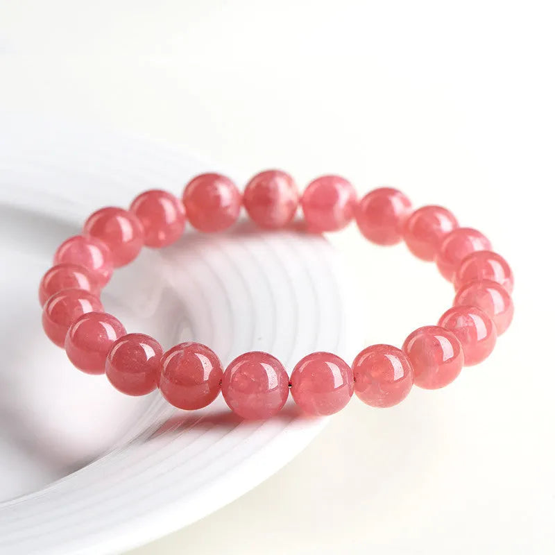Women's red rhodochrosite crystal bracelet with geometric beads and longevity lock clasp