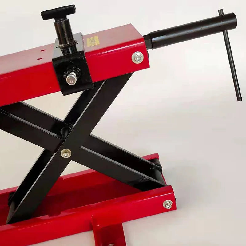 Red motorcycle support lift table raising a bike 16 inches above the ground for repair work