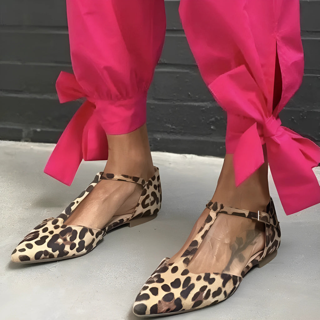 Leopard print women's pointed toe pumps with a chunky low heel and a cross ankle strap