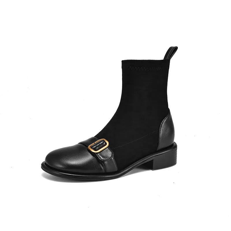 Women's black low heel ankle boots with martin-style buckle stitching and white lace-up front.