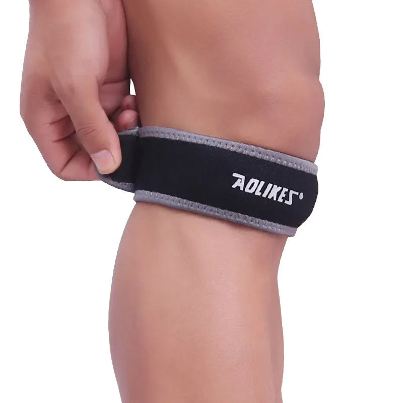 Black and grey adult patella retinaculum knee pad for sports protection.